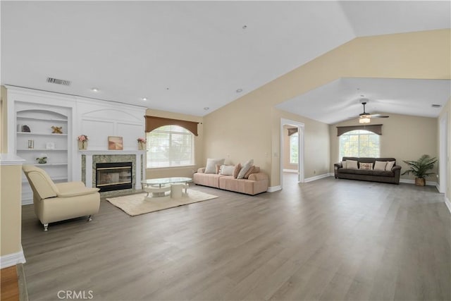 1641 Ford St, Redlands, CA 92373 - living room featuring healthy amount of natural light, lofted ceiling, light wood-style flooring, a premium fireplace, and ceiling fan