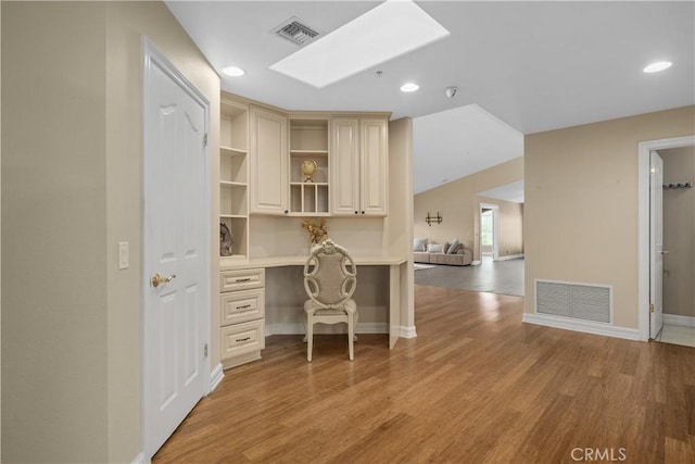 1641 Ford St, Redlands, CA 92373 - office area featuring light wood-style flooring, baseboards, recessed lighting, and a skylight
