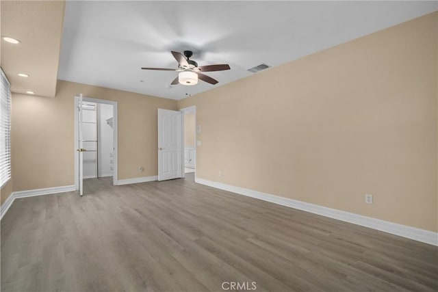 1641 Ford St, Redlands, CA 92373 - unfurnished bedroom with baseboards, wood finished floors, recessed lighting, a ceiling fan, and a walk in closet