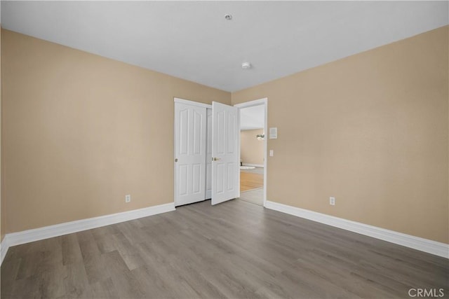 1641 Ford St, Redlands, CA 92373 - unfurnished bedroom featuring baseboards and wood finished floors