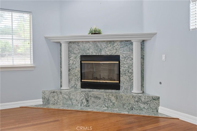 1641 Ford St, Redlands, CA 92373 - detailed view of baseboards, a fireplace, and wood finished floors