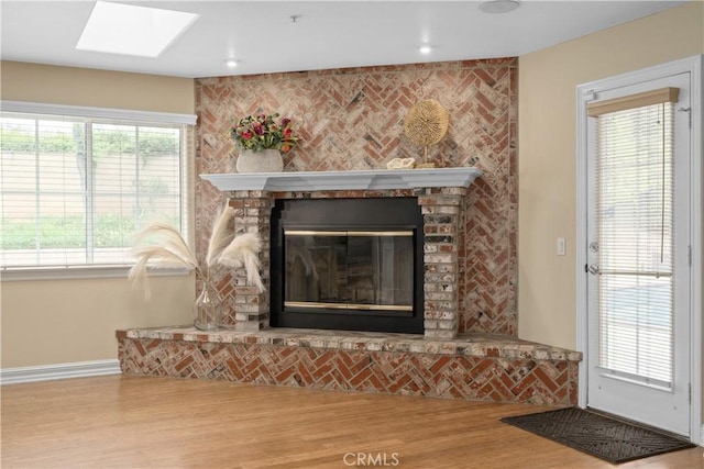 1641 Ford St, Redlands, CA 92373 - detailed view of wood finished floors, a fireplace, a skylight, and baseboards