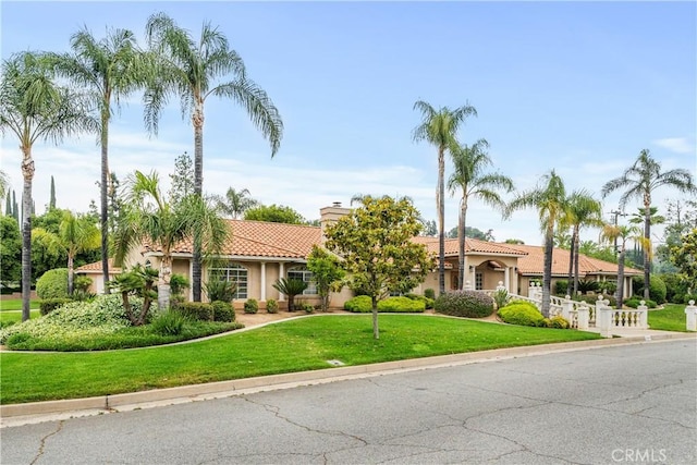 1641 Ford St, Redlands, CA 92373 - mediterranean / spanish home with a tile roof, stucco siding, a chimney, and a front yard