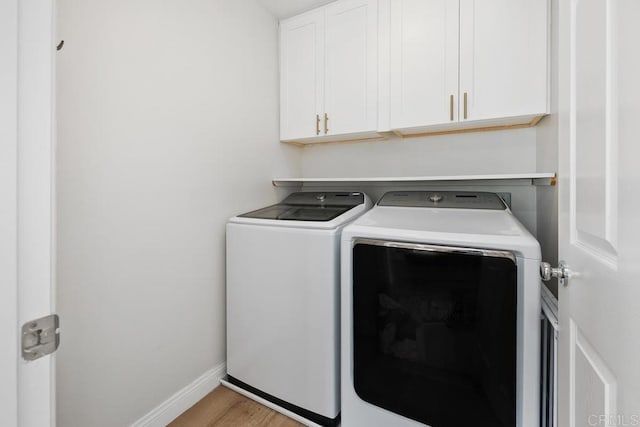 16231 Palomino Mesa Ct, San Diego, CA 92127 - laundry area with separate washer and dryer, cabinet space, wood finished floors, and baseboards
