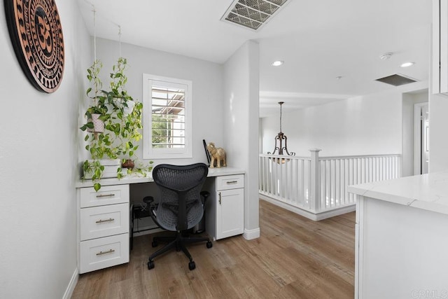 16231 Palomino Mesa Ct, San Diego, CA 92127 - home office with light wood finished floors, built in desk, baseboards, and recessed lighting