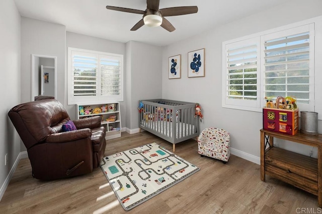 16231 Palomino Mesa Ct, San Diego, CA 92127 - bedroom featuring multiple windows, baseboards, wood finished floors, and a crib
