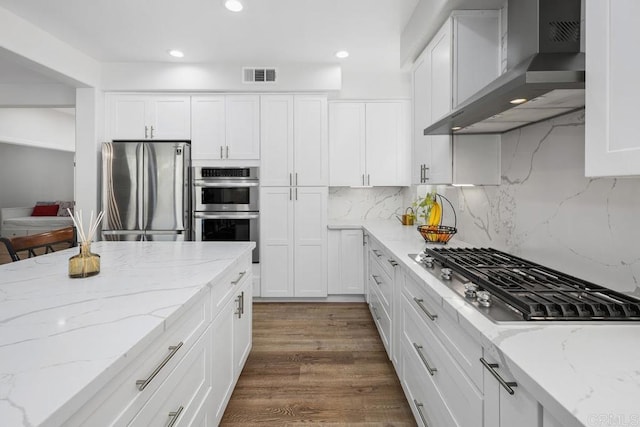16231 Palomino Mesa Ct, San Diego, CA 92127 - kitchen with stainless steel appliances, wall chimney exhaust hood, white cabinetry, decorative backsplash, and recessed lighting
