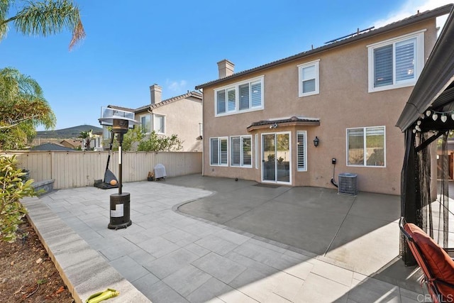 16231 Palomino Mesa Ct, San Diego, CA 92127 - back of property featuring stucco siding, a chimney, a fenced backyard, and a patio