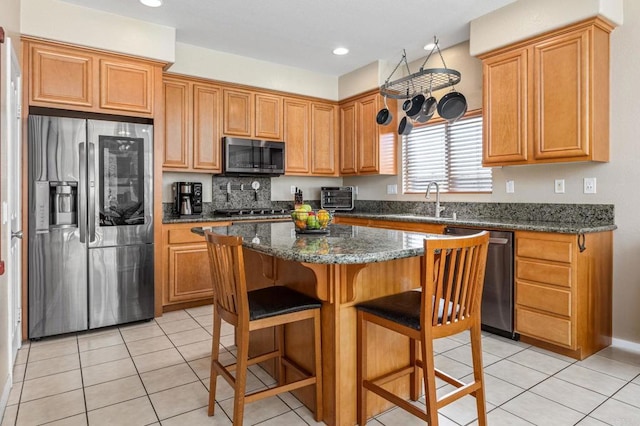 2292 Marquand Ct, Alpine, CA 91901 - kitchen featuring appliances with stainless steel finishes, a sink, a center island, a breakfast bar, and light tile patterned floors