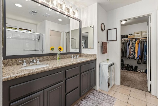 2292 Marquand Ct, Alpine, CA 91901 - bathroom with double vanity, a spacious closet, tile patterned flooring, and an enclosed shower