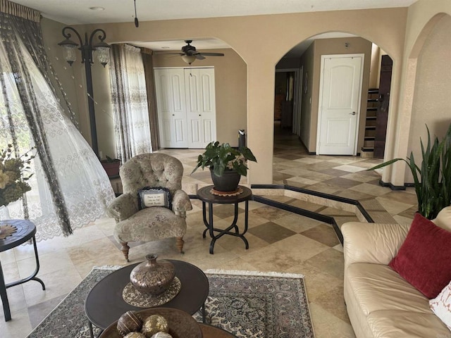 6591 Black Rail Rd, Carlsbad, CA 92011 - living area with arched walkways, ceiling fan, and baseboards