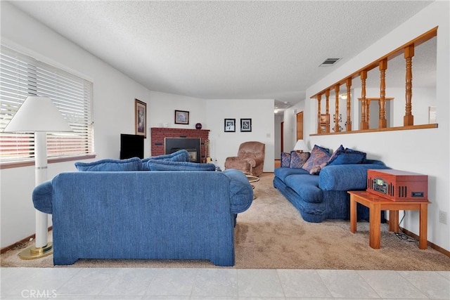 8960 Guava Ave, Hesperia, CA 92345 - living area with light carpet, a textured ceiling, a fireplace, and baseboards
