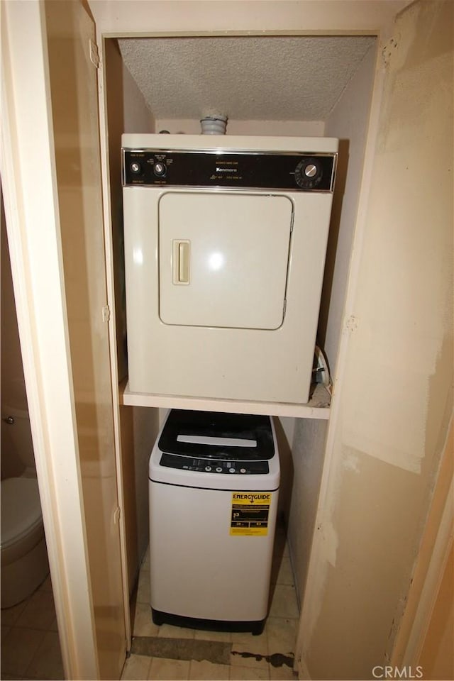23362 La Mar Unit A, Mission Viejo, CA 92691 - washroom with stacked washer and clothes dryer, a textured ceiling, and light tile patterned floors
