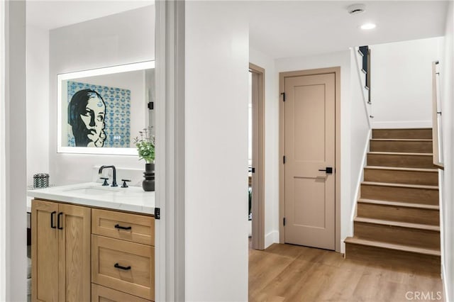 9802 Effingham Dr, Huntington Beach, CA 92646 - bar featuring light wood finished floors, a sink, stairway, and recessed lighting