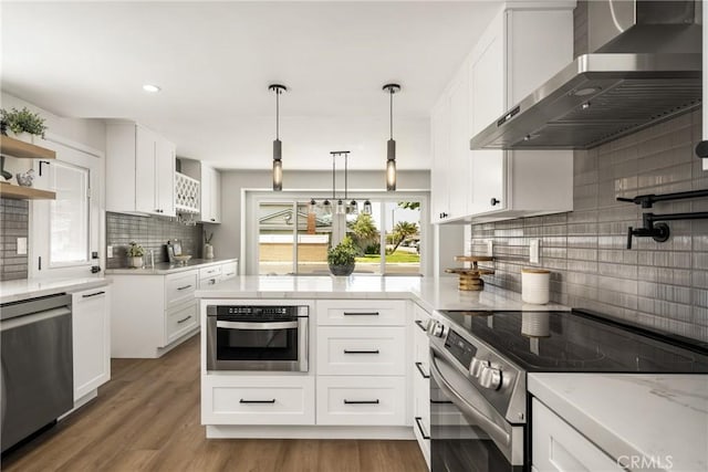 9802 Effingham Dr, Huntington Beach, CA 92646 - kitchen with wall chimney exhaust hood, stainless steel appliances, decorative backsplash, a peninsula, and open shelves