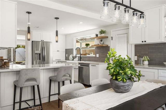 9802 Effingham Dr, Huntington Beach, CA 92646 - kitchen featuring appliances with stainless steel finishes, white cabinetry, backsplash, and recessed lighting