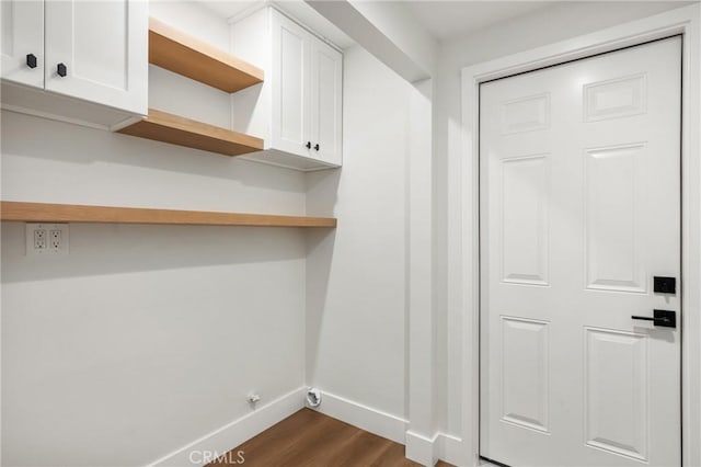 9802 Effingham Dr, Huntington Beach, CA 92646 - laundry room featuring dark wood-style floors, baseboards, and cabinet space