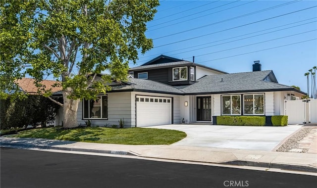 9802 Effingham Dr, Huntington Beach, CA 92646 - traditional home featuring an attached garage, concrete driveway, a chimney, a gate, and roof with shingles