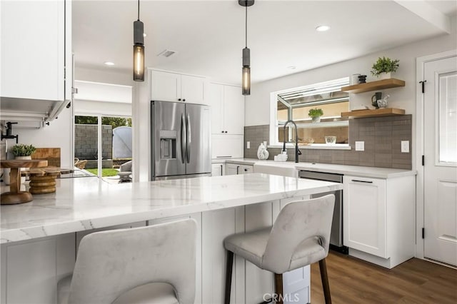 9802 Effingham Dr, Huntington Beach, CA 92646 - kitchen featuring stainless steel appliances, a peninsula, white cabinets, dark wood-style flooring, and recessed lighting