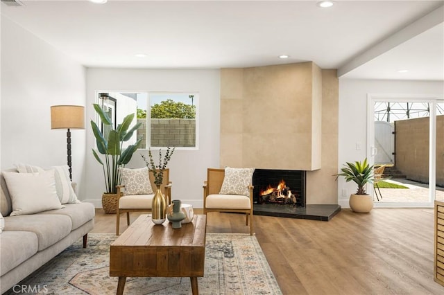 9802 Effingham Dr, Huntington Beach, CA 92646 - living room with recessed lighting, wood finished floors, a premium fireplace, and baseboards