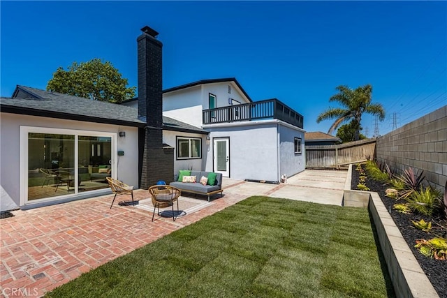 9802 Effingham Dr, Huntington Beach, CA 92646 - back of house with a balcony, an outdoor living space, a patio, stucco siding, and a chimney