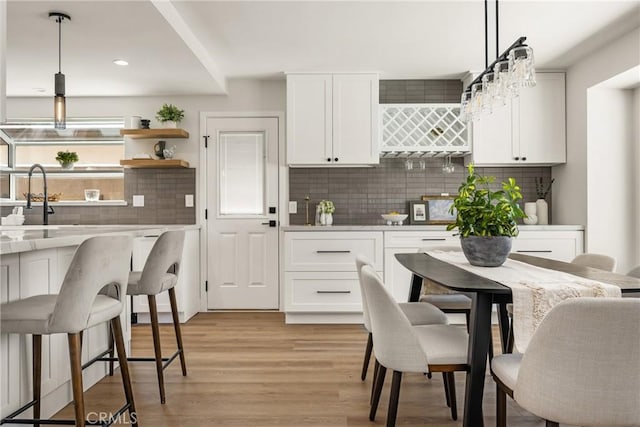 9802 Effingham Dr, Huntington Beach, CA 92646 - kitchen with backsplash, light countertops, white cabinetry, pendant lighting, and recessed lighting