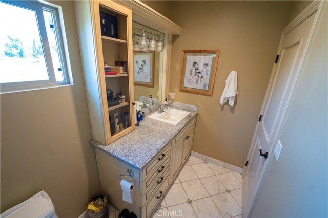 19162 Liggett St, Northridge, CA 91324 - half bathroom featuring vanity, toilet, plenty of natural light, and tile patterned flooring