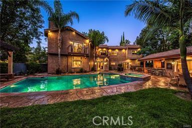 19162 Liggett St, Northridge, CA 91324 - view of swimming pool with a patio area, a pool with connected hot tub, and a lawn