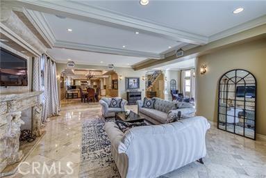 19162 Liggett St, Northridge, CA 91324 - living room featuring crown molding, recessed lighting, a fireplace, and marble finish floors