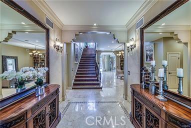 19162 Liggett St, Northridge, CA 91324 - foyer entrance with stairs, marble tiled floors, crown molding, plenty of natural light, and a chandelier