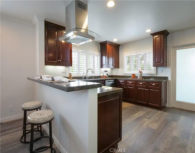 2048 264th St, Lomita, CA 90717 - kitchen with island exhaust hood, a breakfast bar, wood finished floors, a sink, and plenty of natural light