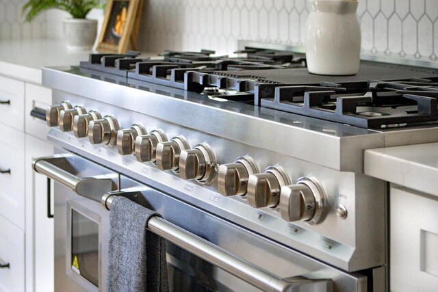 1051 Via Rancho Pkwy, Escondido, CA 92029 - kitchen view of high end stainless steel range and tasteful backsplash
