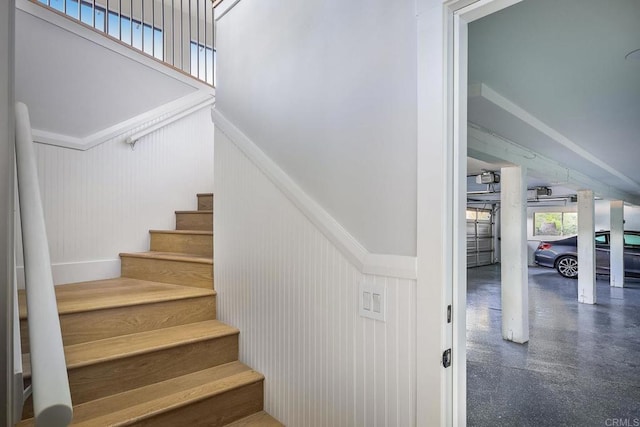 1051 Via Rancho Pkwy, Escondido, CA 92029 - stairway with wainscoting and a towering ceiling