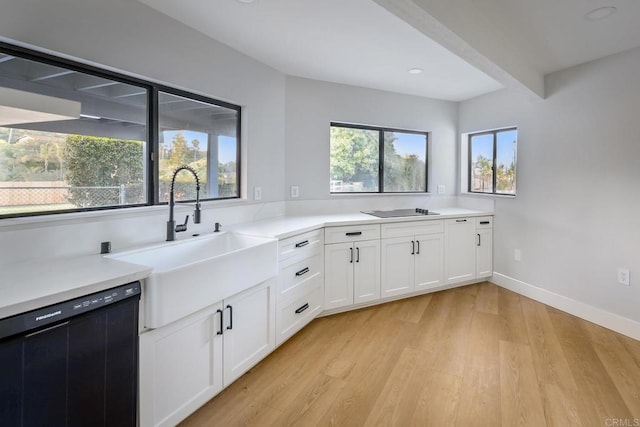 1051 Via Rancho Pkwy, Escondido, CA 92029 - kitchen featuring black appliances, a sink, light wood finished floors, white cabinetry, and light countertops