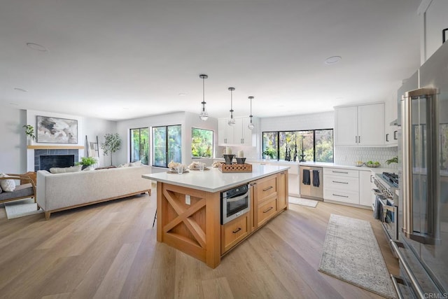 1051 Via Rancho Pkwy, Escondido, CA 92029 - kitchen with light wood-style flooring, high end appliances, light countertops, and open floor plan