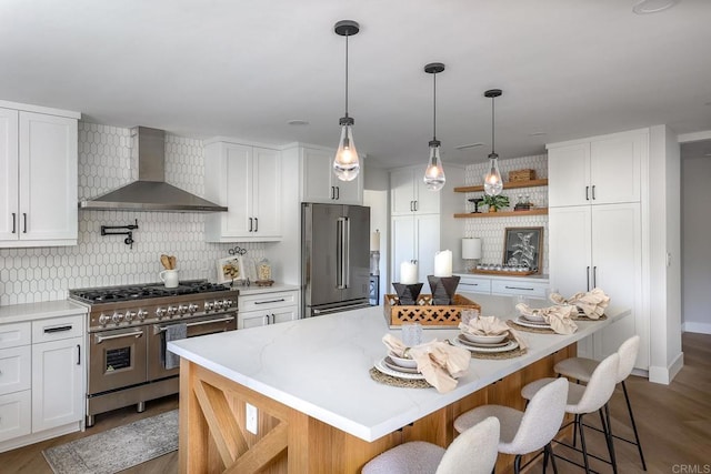 1051 Via Rancho Pkwy, Escondido, CA 92029 - kitchen with wall chimney range hood, high quality appliances, tasteful backsplash, and white cabinets