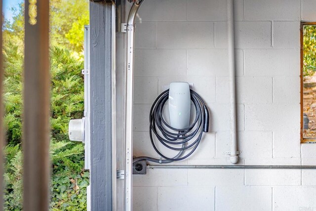 1051 Via Rancho Pkwy, Escondido, CA 92029 - detailed view of concrete block siding and electric vehicle charger