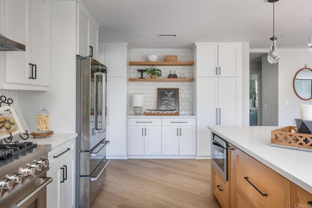 1051 Via Rancho Pkwy, Escondido, CA 92029 - kitchen featuring appliances with stainless steel finishes, wall chimney range hood, light countertops, and light wood-type flooring
