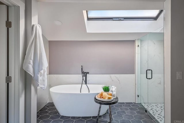 1051 Via Rancho Pkwy, Escondido, CA 92029 - full bath featuring tile walls, a freestanding bath, a marble finish shower, a wainscoted wall, and tile patterned flooring