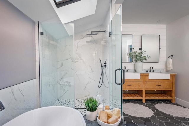 1051 Via Rancho Pkwy, Escondido, CA 92029 - bathroom featuring double vanity, a marble finish shower, a freestanding tub, tile walls, and a skylight