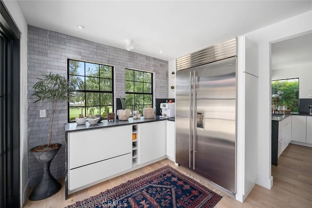 5933 Birkdale Ln, San Luis Obispo, CA 93401 - kitchen featuring built in refrigerator, modern cabinets, white cabinets, dark countertops, and light wood finished floors