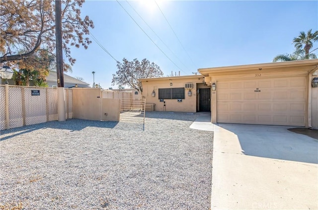 332 E 7th St, San Jacinto, CA 92583 - view of front of house featuring concrete driveway, stucco siding, and an attached garage