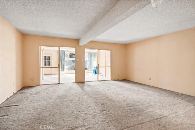 332 E 7th St, San Jacinto, CA 92583 - unfurnished room featuring carpet, a textured ceiling, and beam ceiling