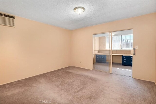 332 E 7th St, San Jacinto, CA 92583 - empty room with carpet and a textured ceiling