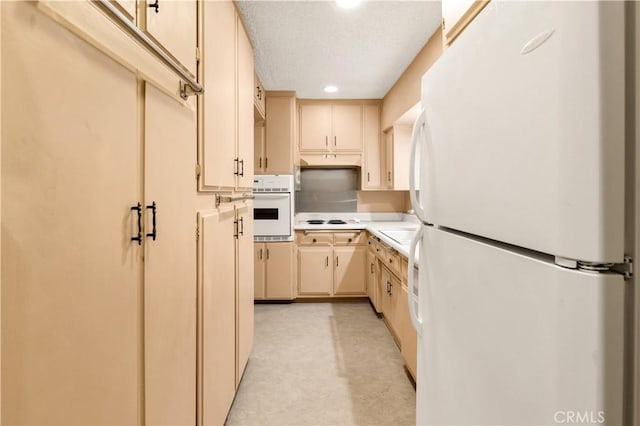 332 E 7th St, San Jacinto, CA 92583 - kitchen featuring white appliances, cream cabinetry, light countertops, recessed lighting, and a sink