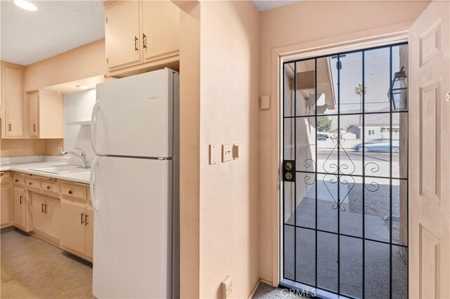 332 E 7th St, San Jacinto, CA 92583 - kitchen with freestanding refrigerator, a sink, and light countertops