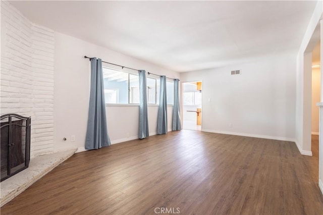 15903 Bryant St, North Hills, CA 91343 - unfurnished living room with a fireplace, wood finished floors, and baseboards