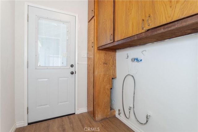 15903 Bryant St, North Hills, CA 91343 - laundry room featuring cabinet space, wood finished floors, and baseboards