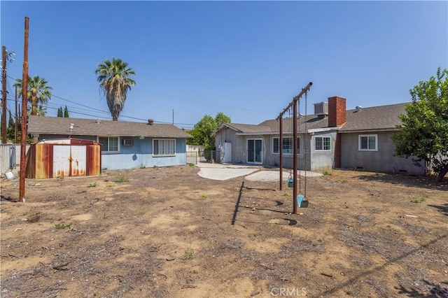 15903 Bryant St, North Hills, CA 91343 - rear view of house with central AC unit and a chimney