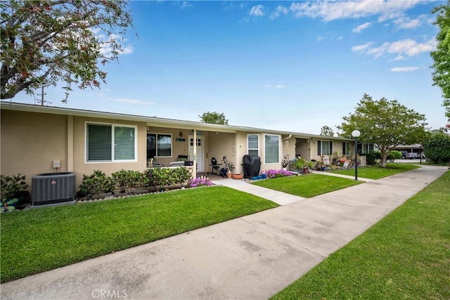 1420 Northwood Rd Unit 241C, Seal Beach, CA 90740 - single story home with stucco siding, central AC unit, and a front yard
